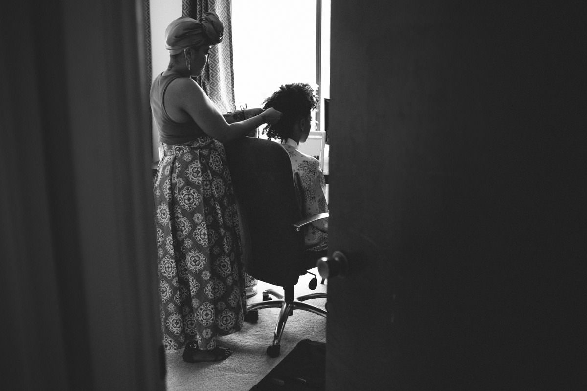 bride getting her hair done for wedding