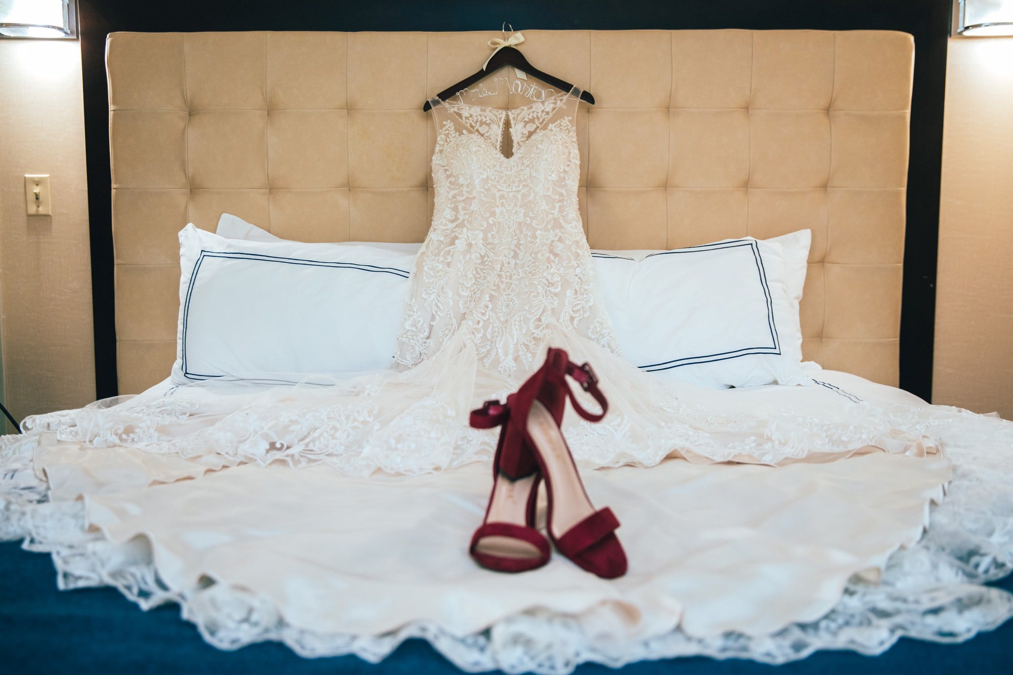wedding dress and shoes on bed