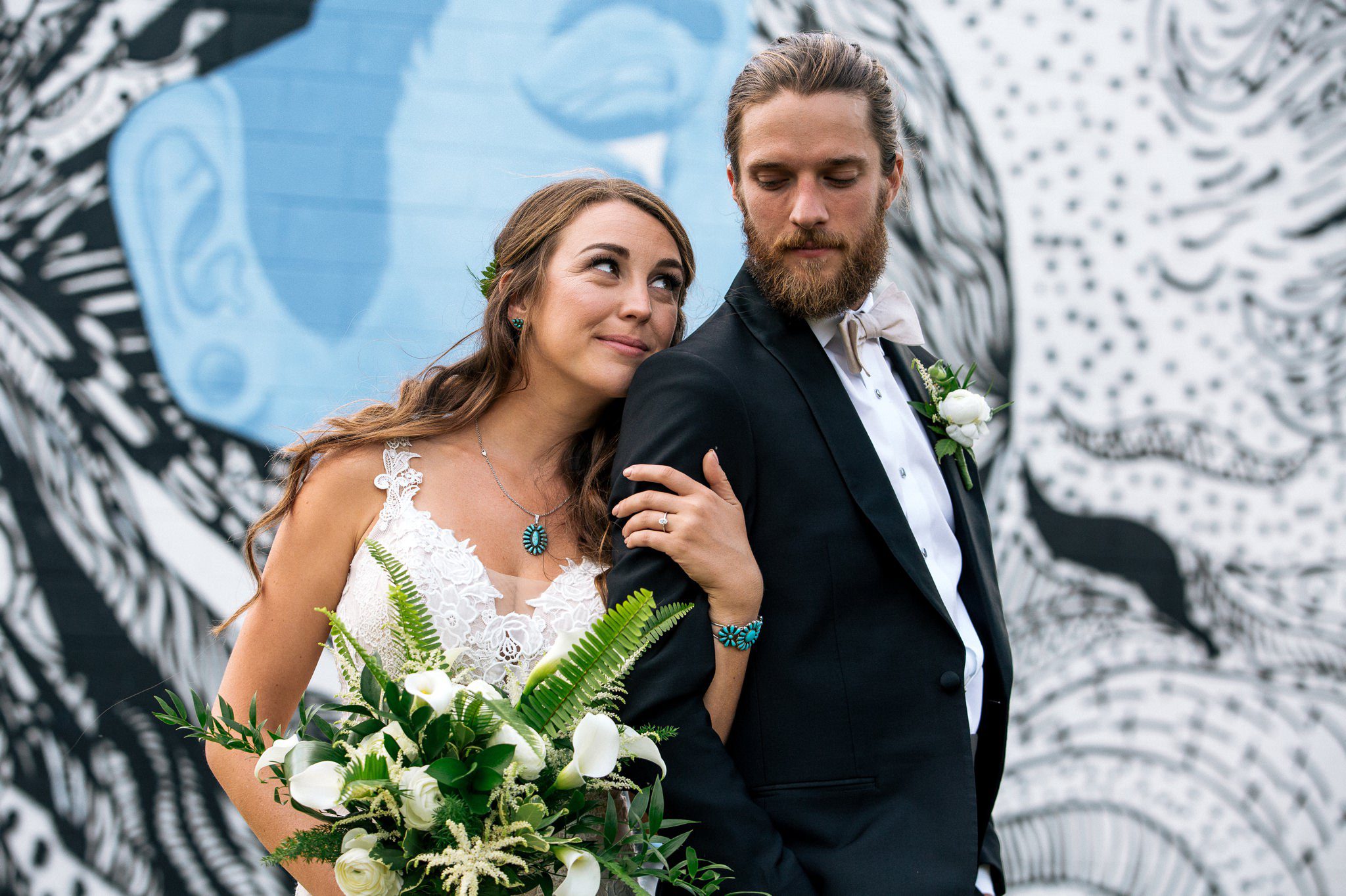 wedding photo in front of mural