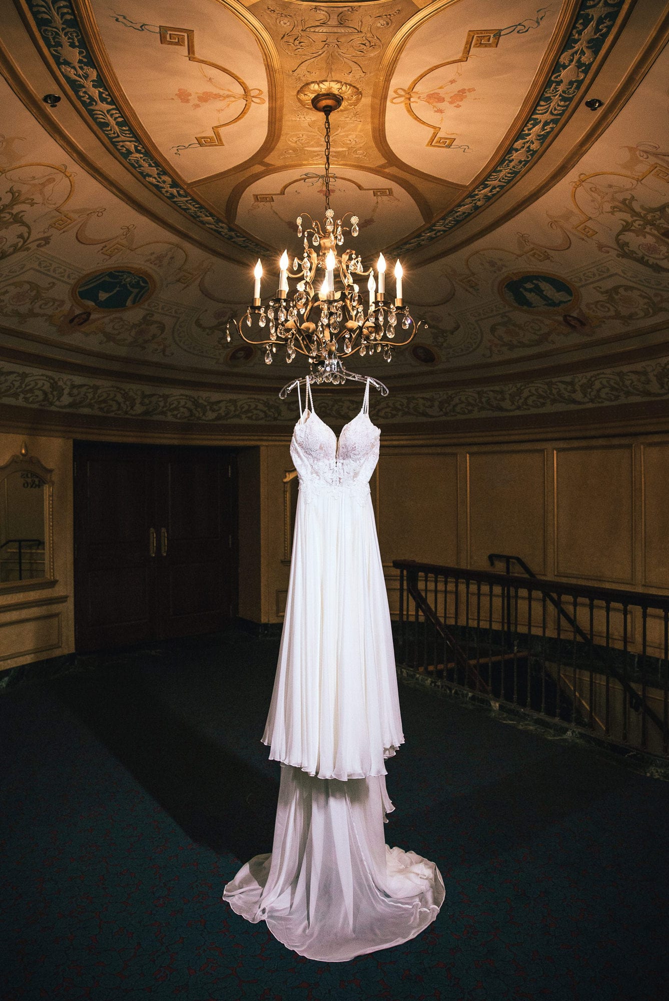 dress hanging from chandelier