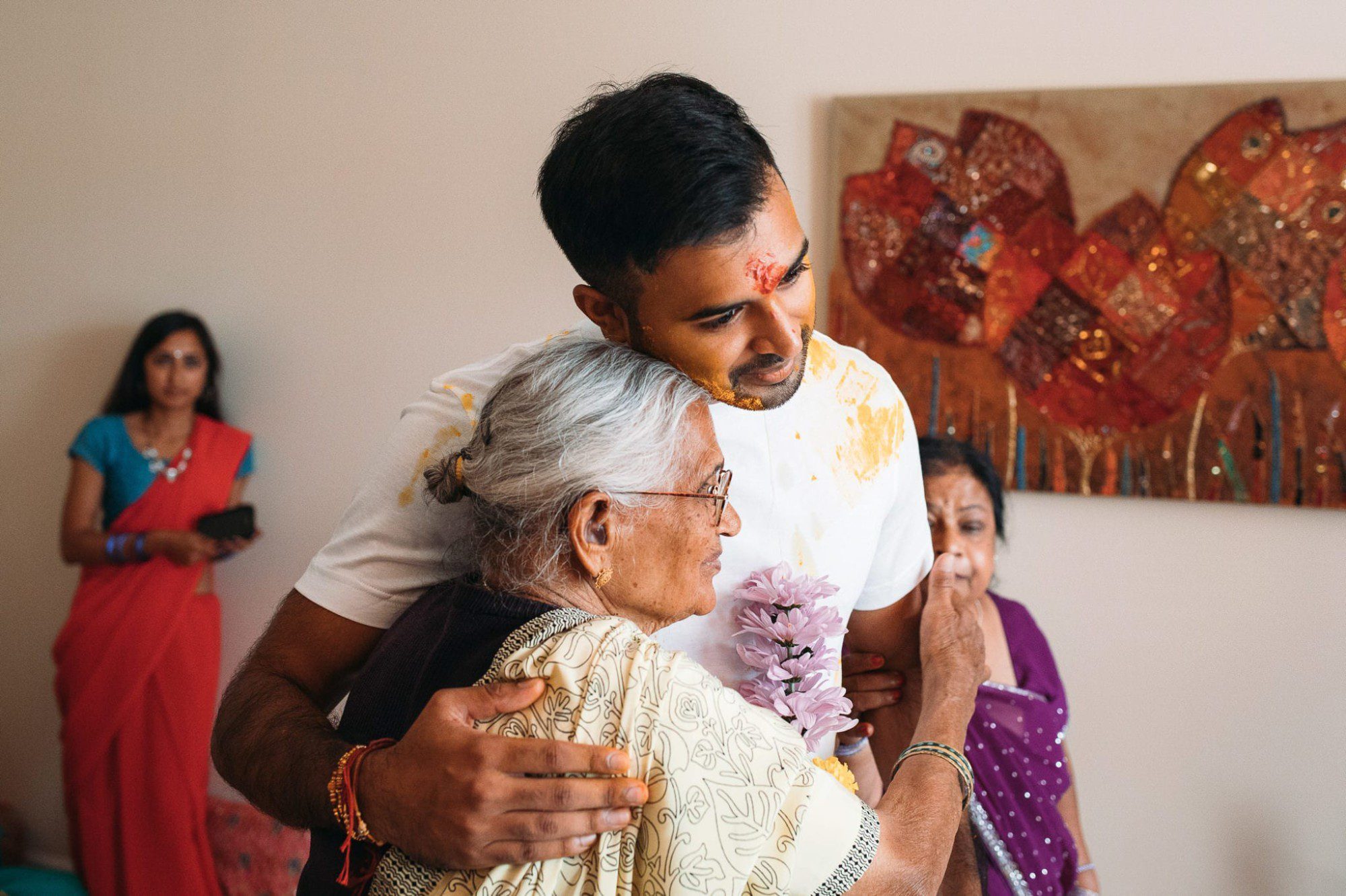 Indian groom hugging his grandmother