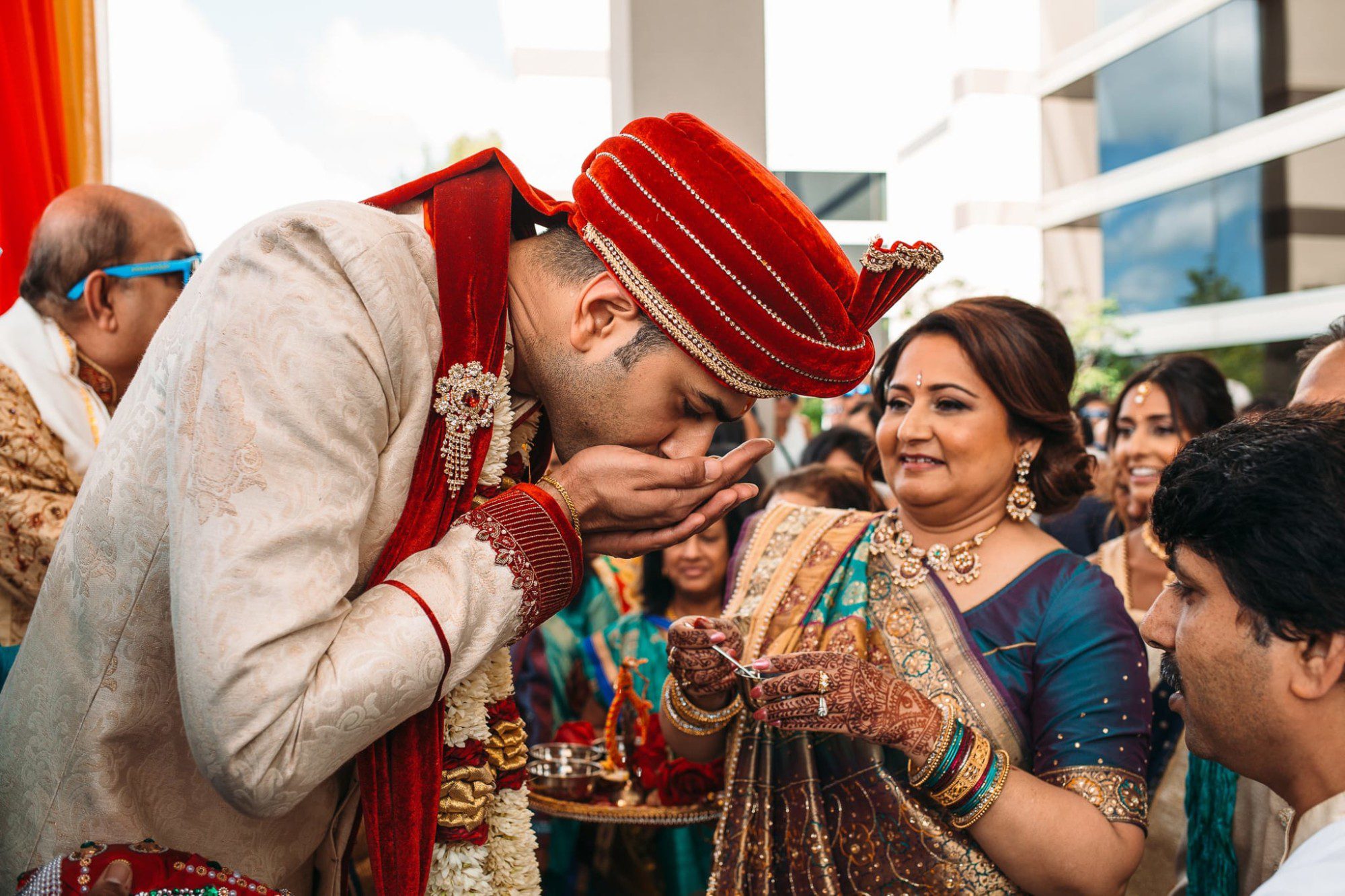 Indian groom drink water out of his hands