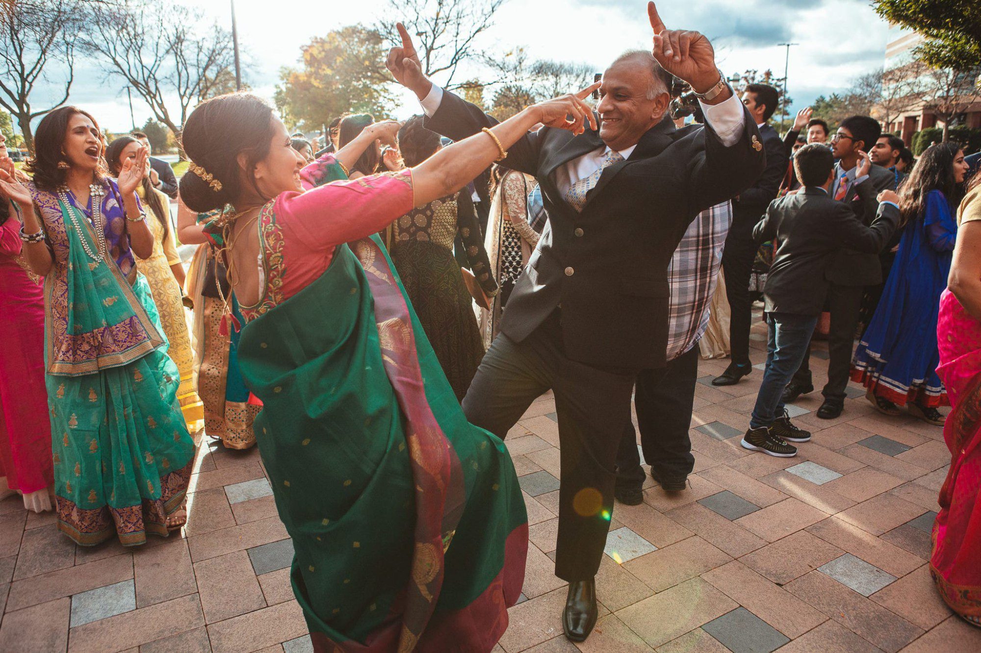 man and woman dancing during Indian wedding baraat