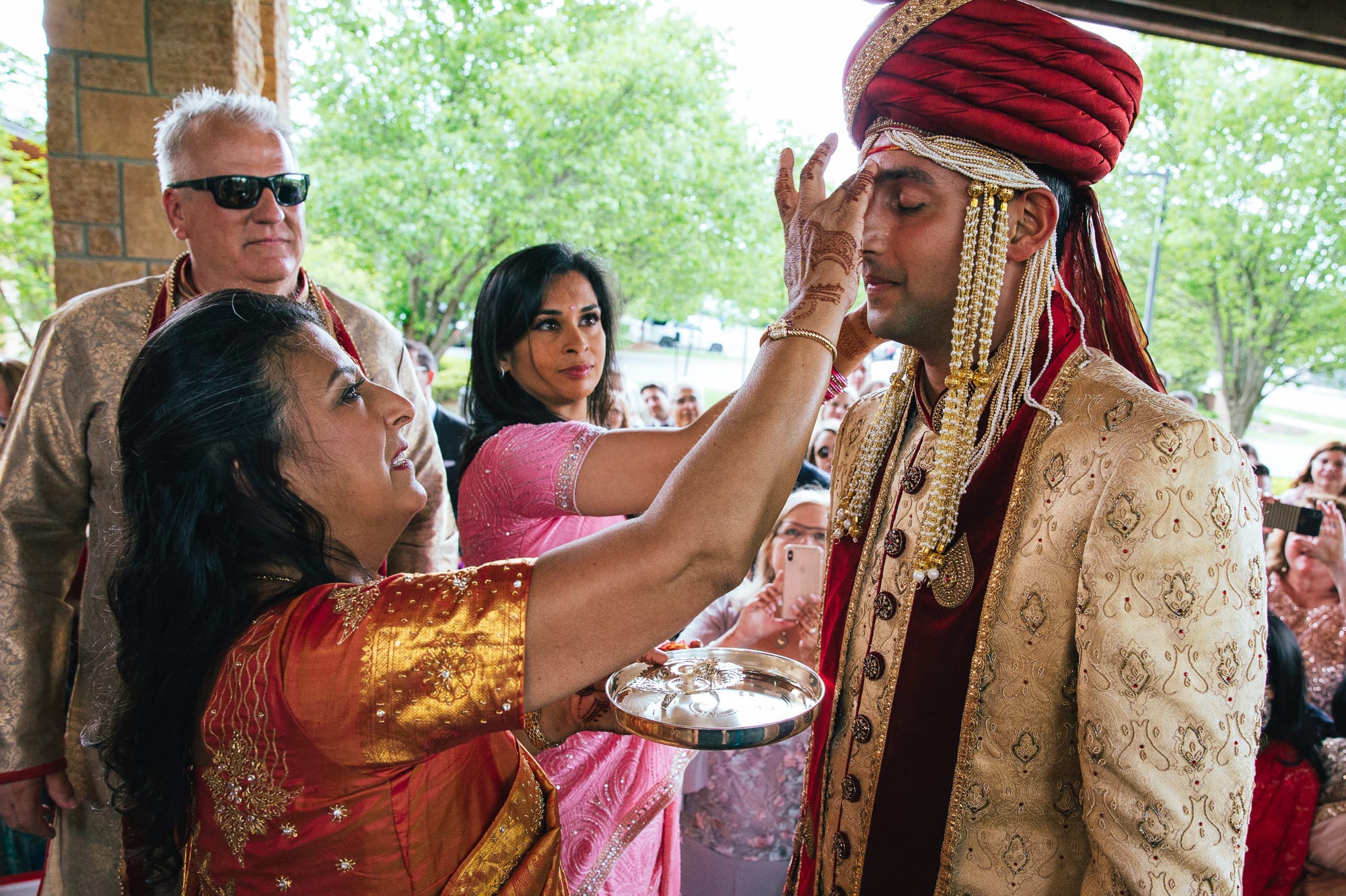 family welcoming Indian groom
