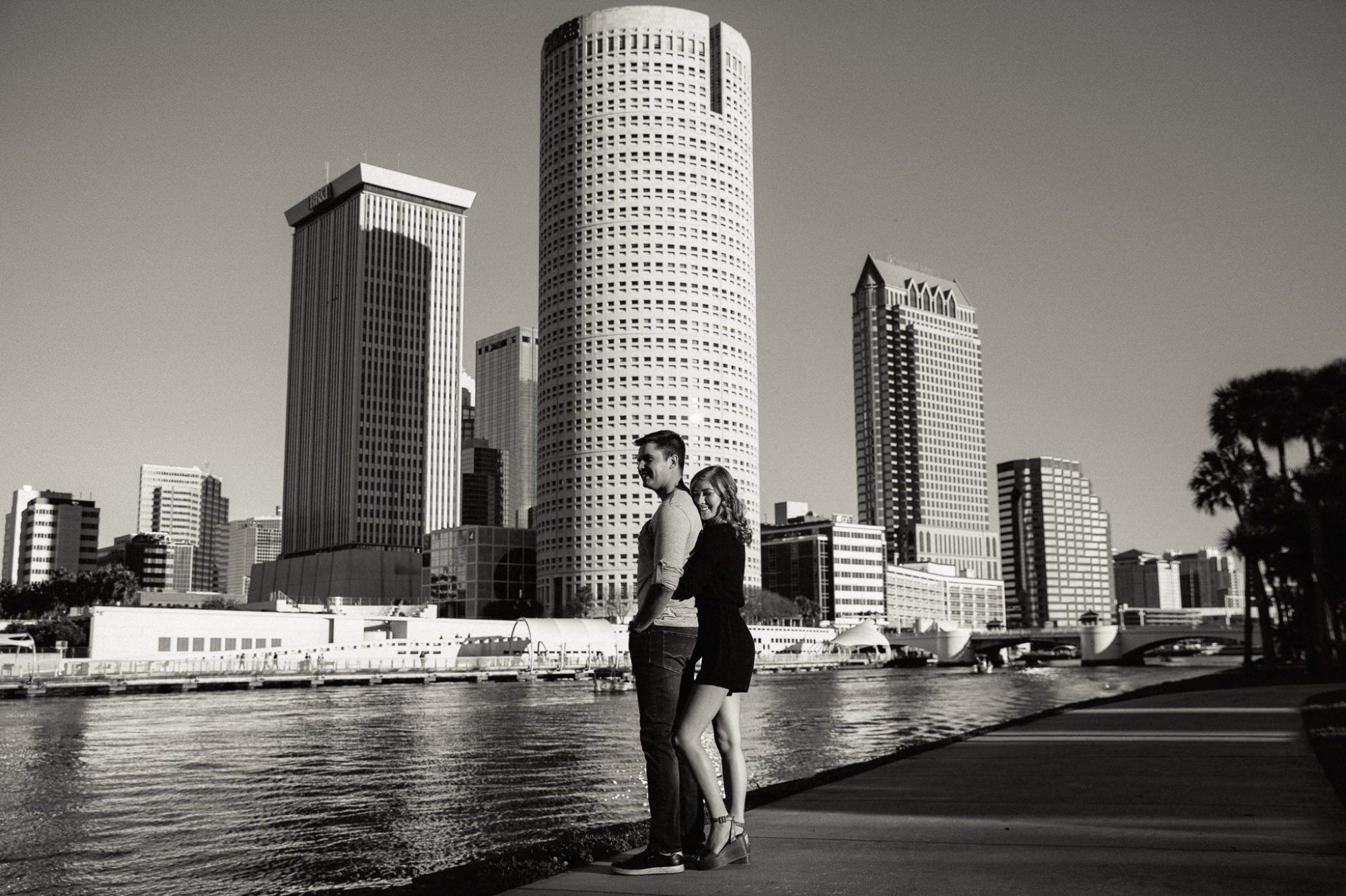 couple hugging with Tampa skyline in background