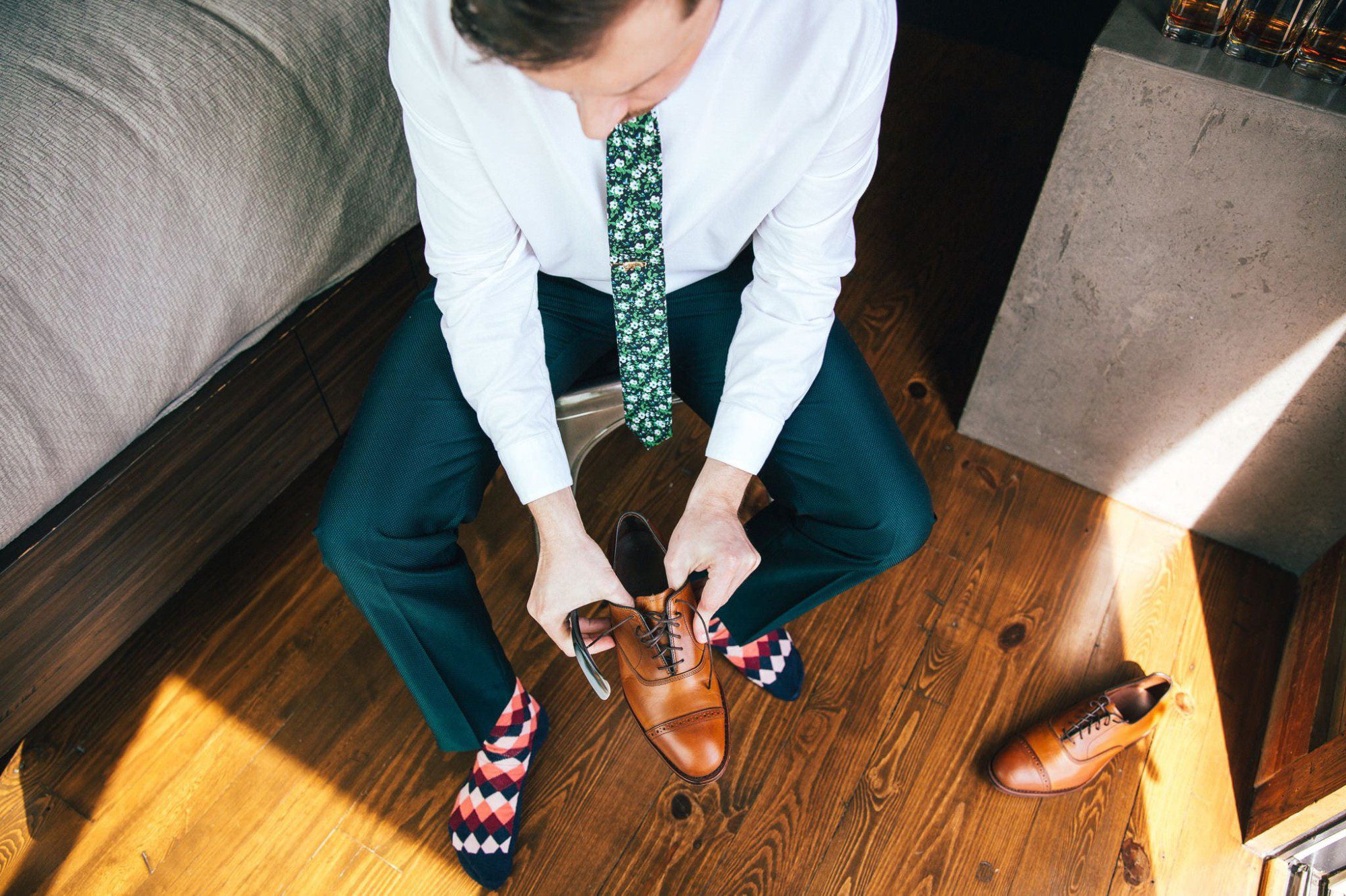 groom putting on his dress shoes