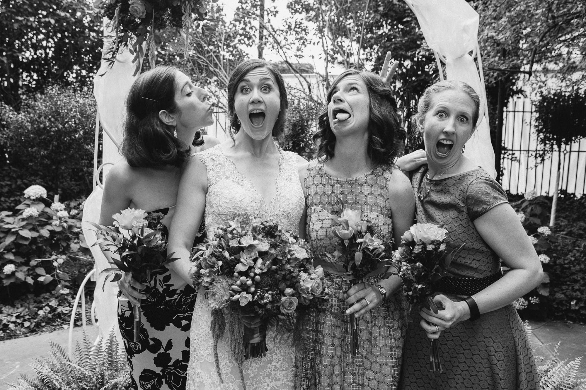 bride and sisters making silly faces for camera