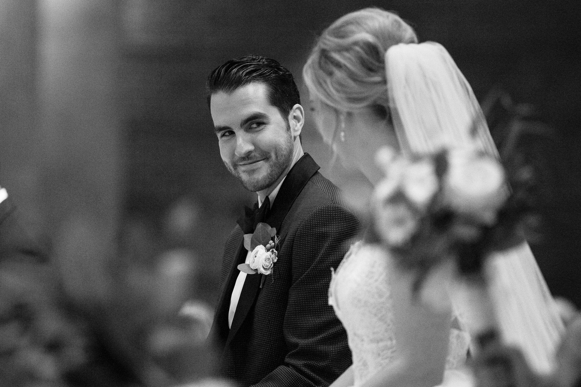 groom looking over at bride during wedding ceremony