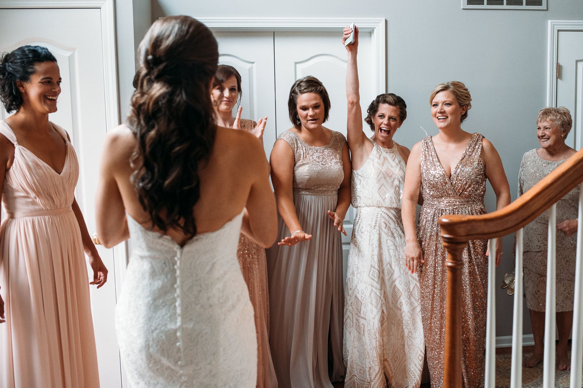 bridesmaids reacting to seeing bride in wedding dress