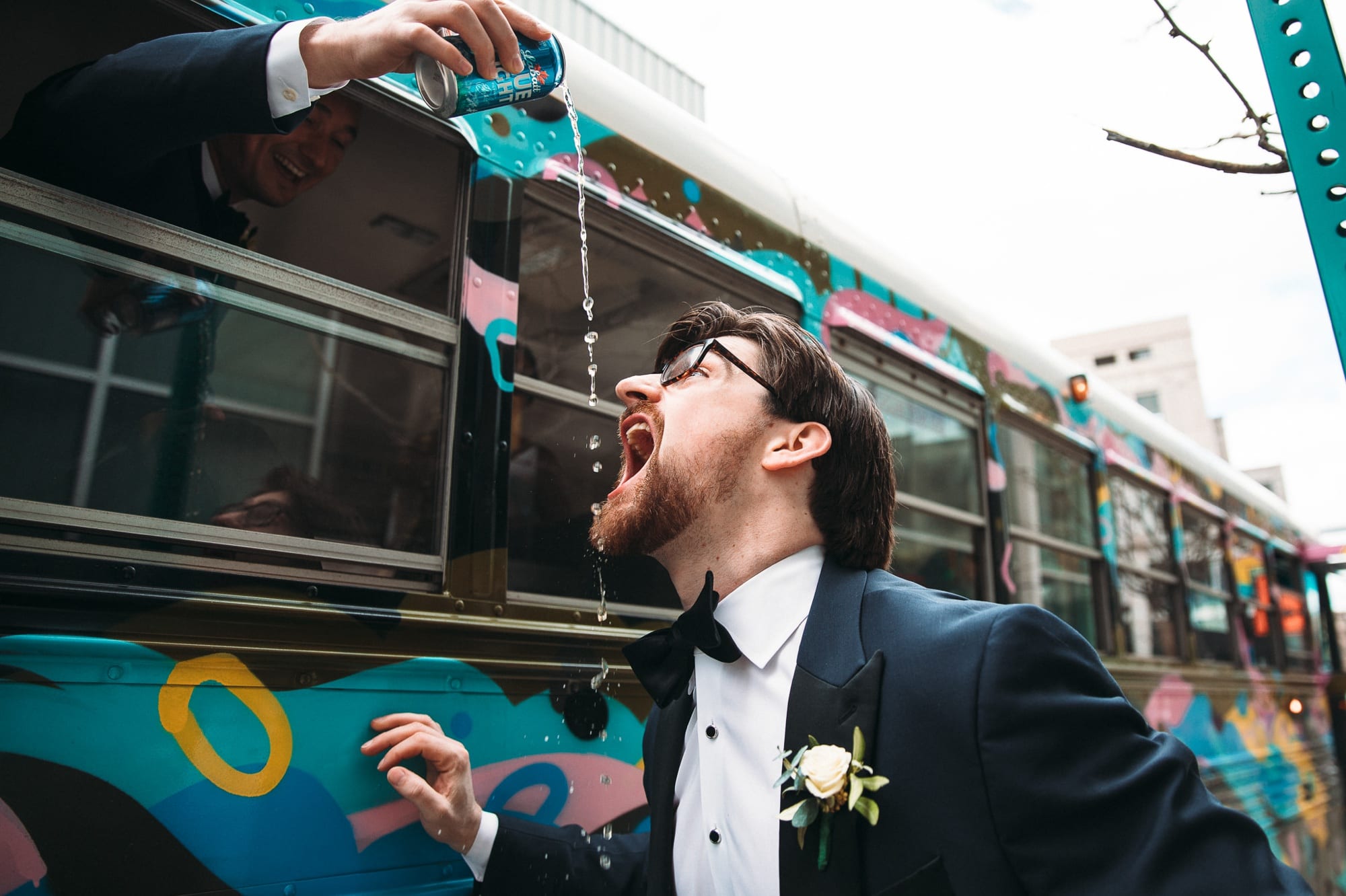 groomsman pouring beer into grooms mouth