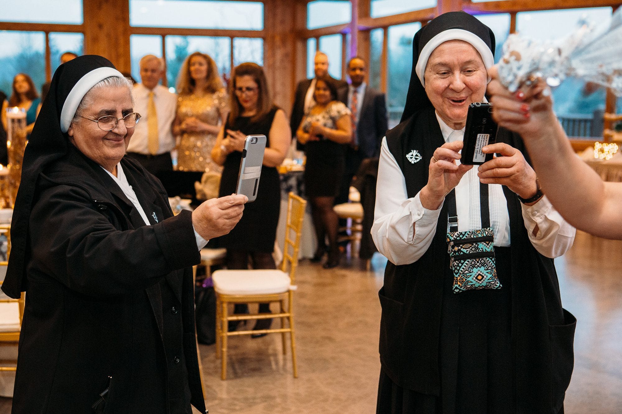 Two nuns recording bride dancing
