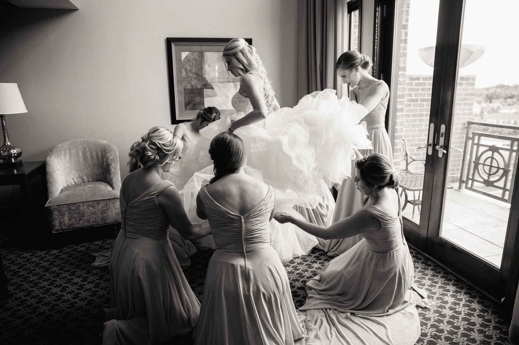 bridesmaids helping bride get dressed at the Inn of St John's