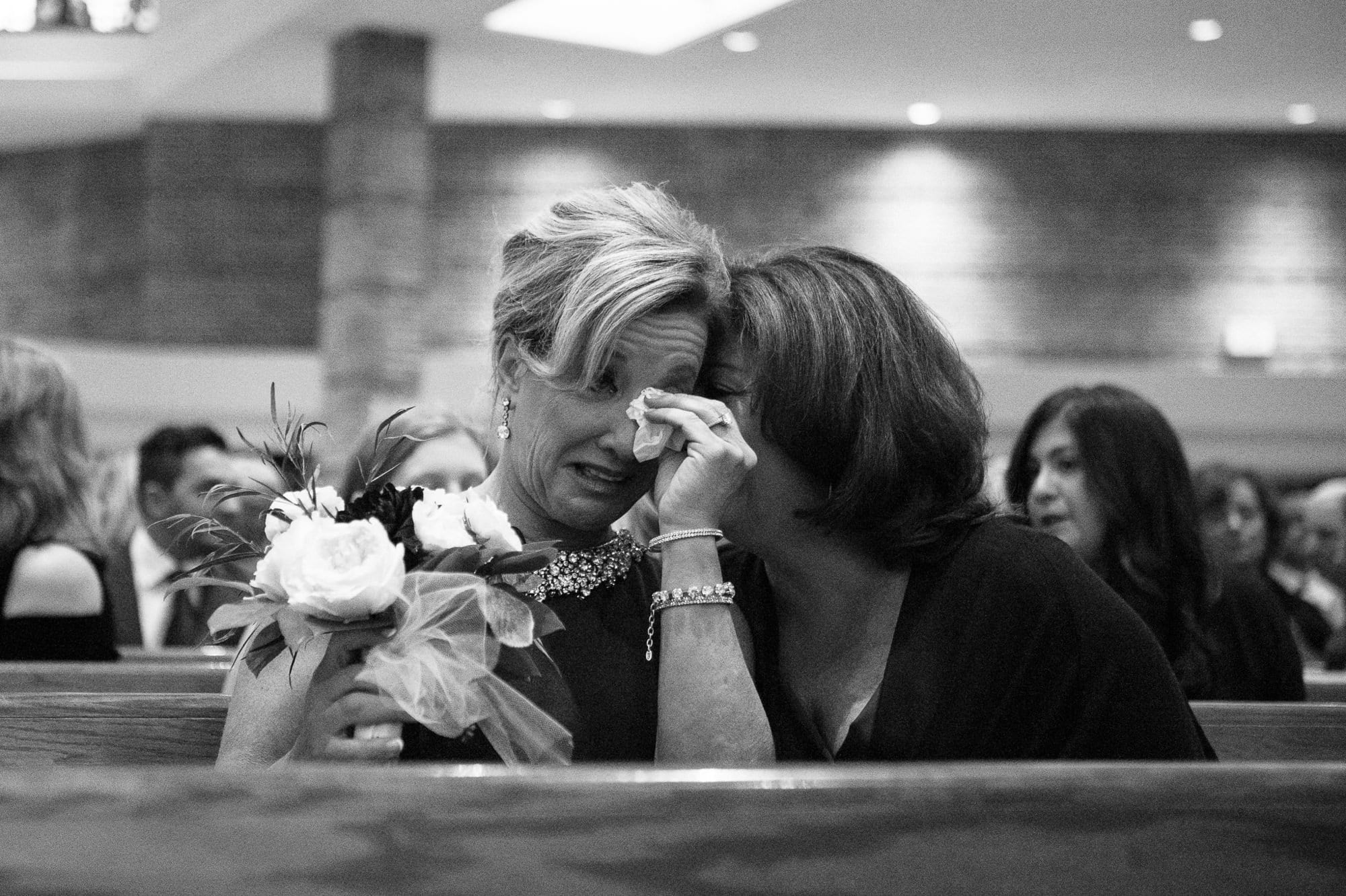 Mother of groom crying during wedding ceremony