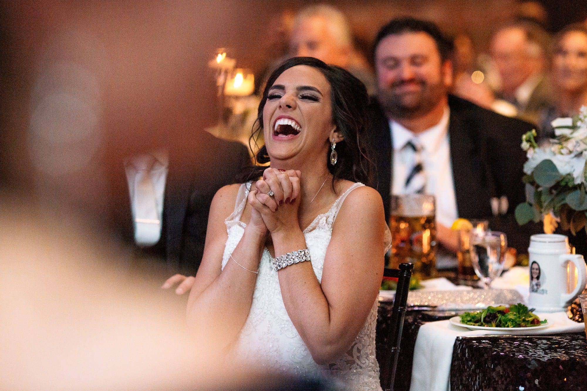 bride laughing during wedding reception