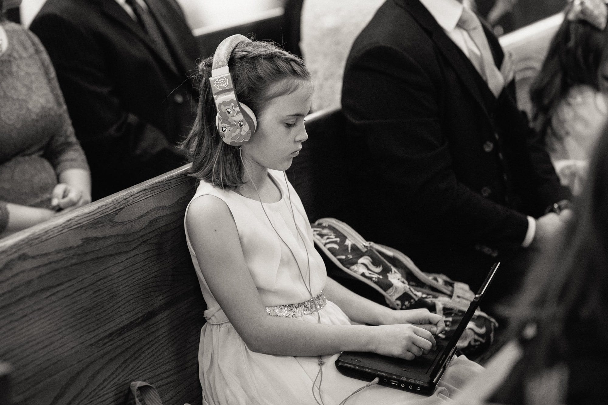 young girl on laptop with headphones on