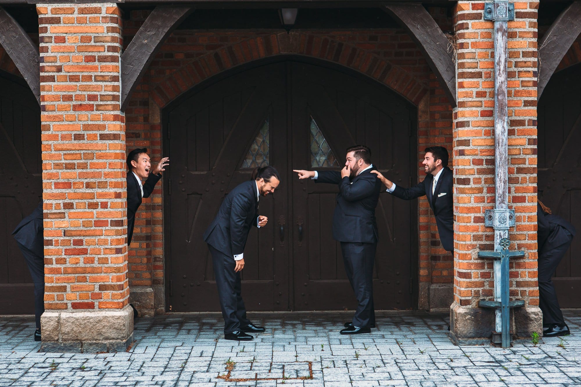 groom and groomsmen acting silly outside Meadowbrook Hall