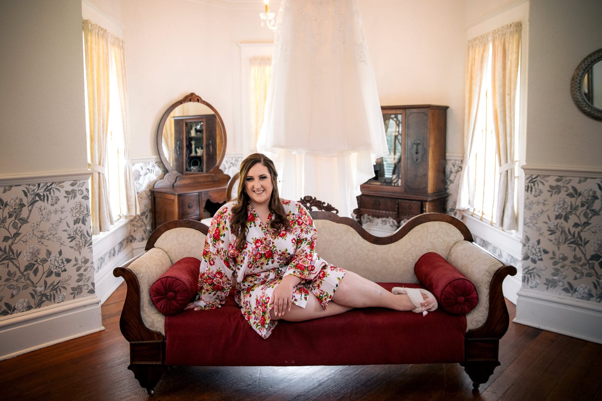 bride sitting on a sofa with in a robe