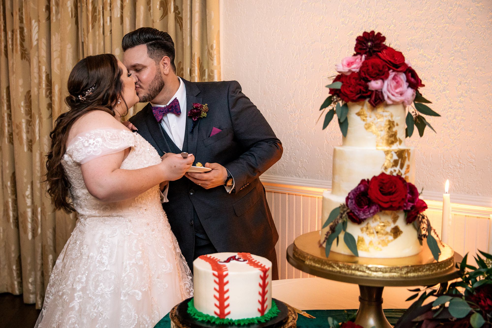 bride and groom kissing after cake cutting