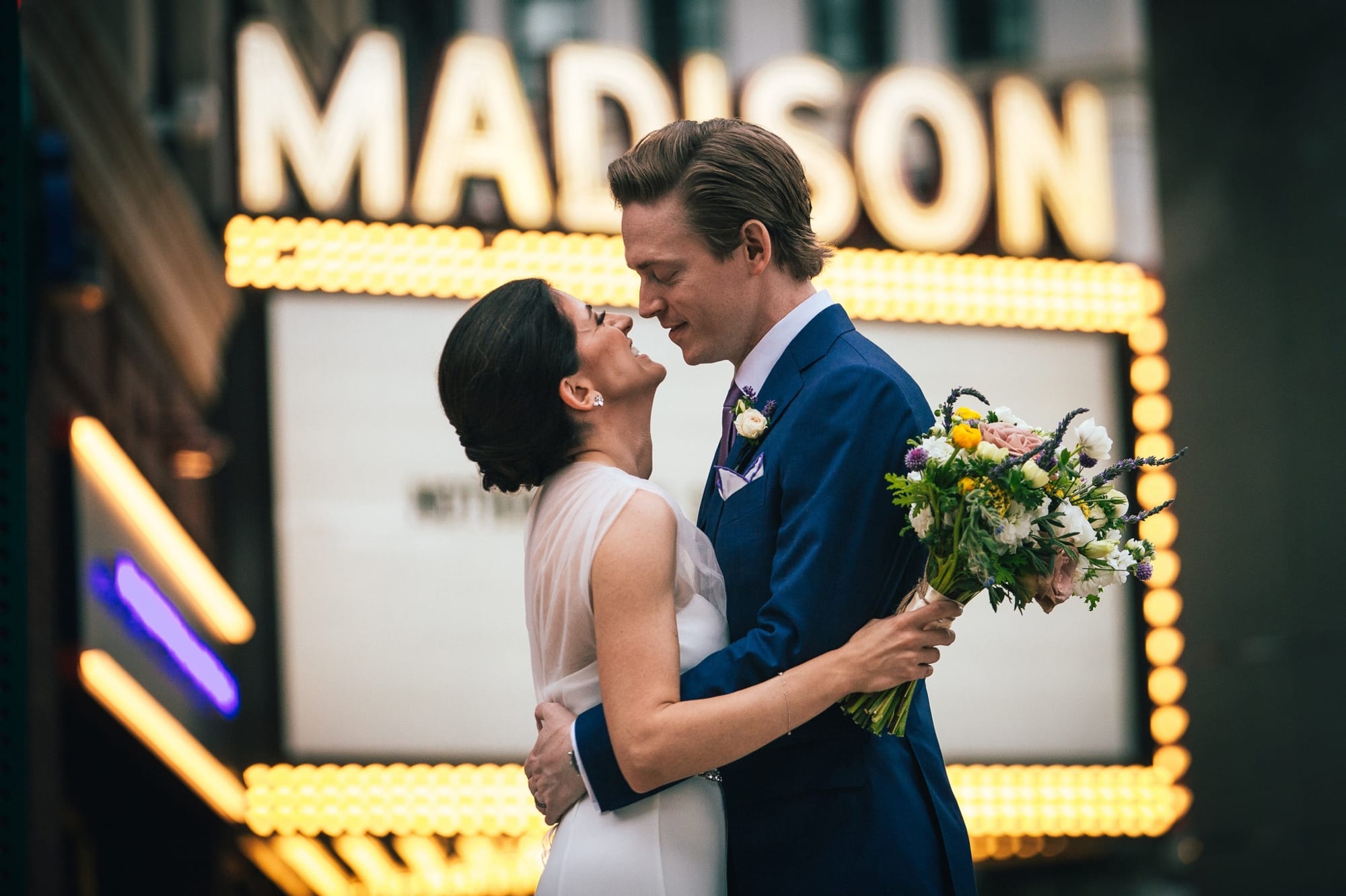 wedding photo in front of Madison Building marquee sign