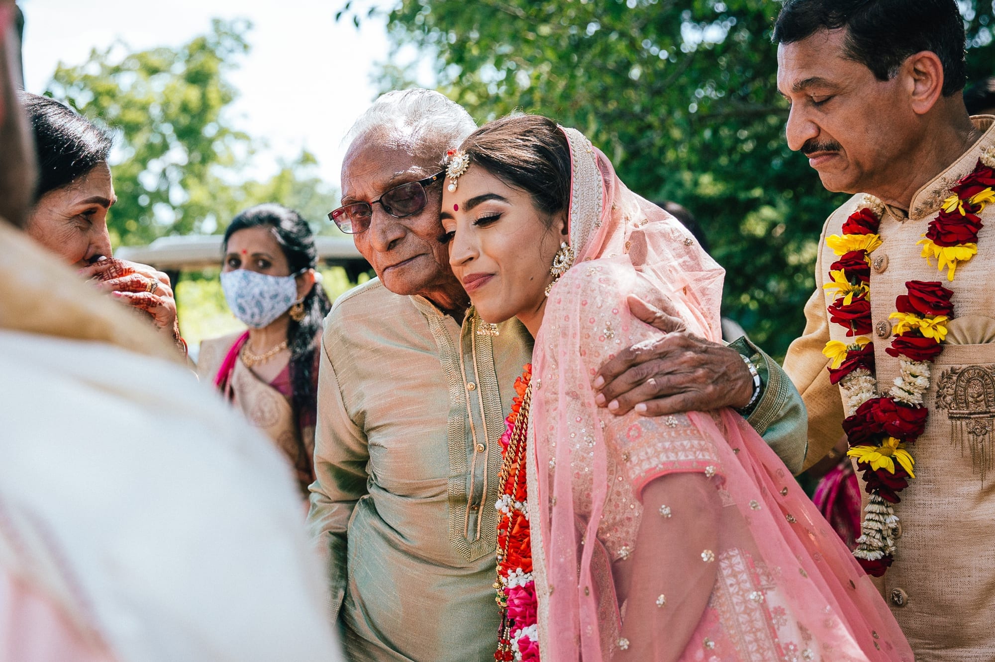 Indian bride hugging grandpa