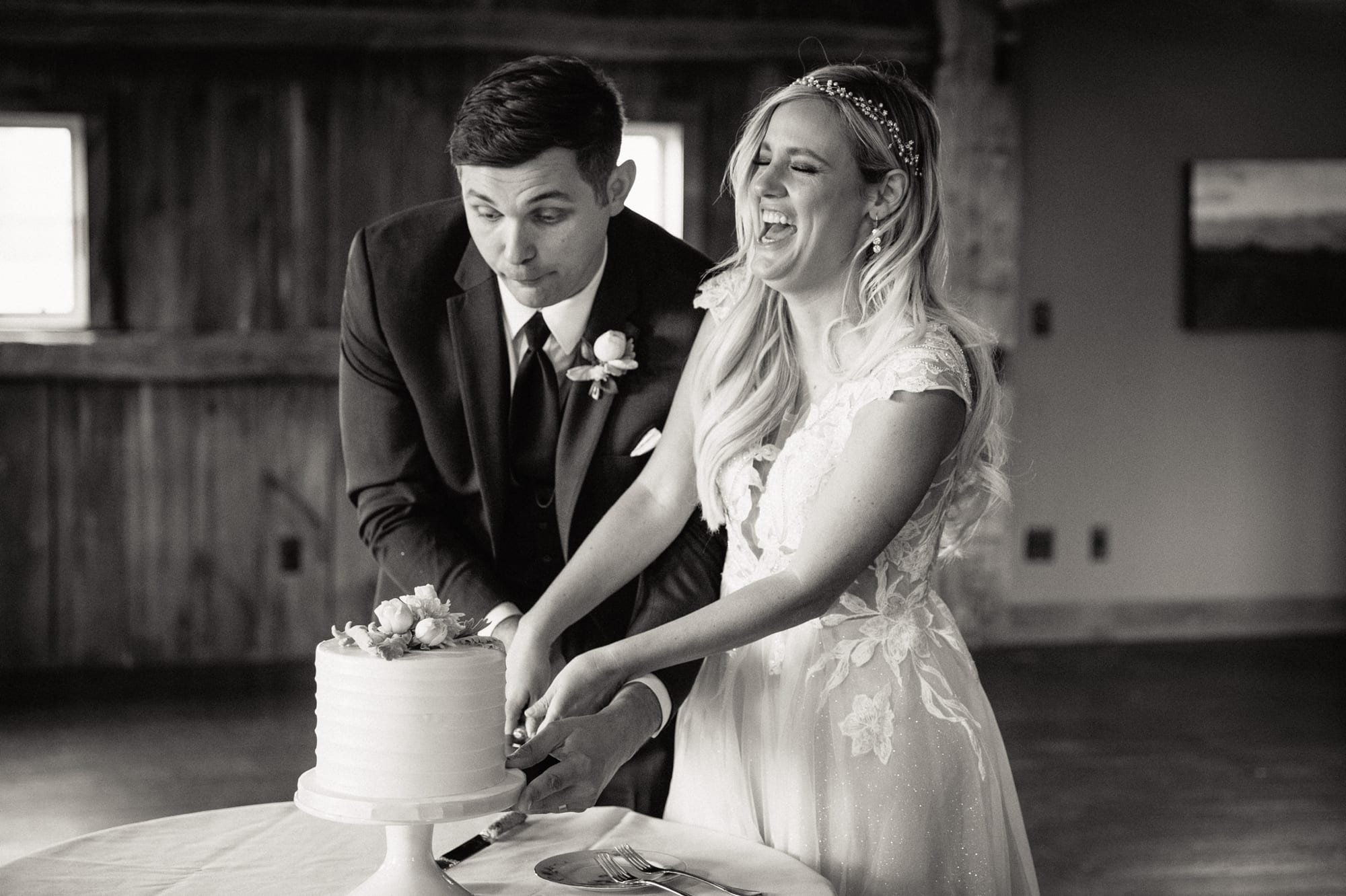 bride and groom cutting cake at Zingerman's farms