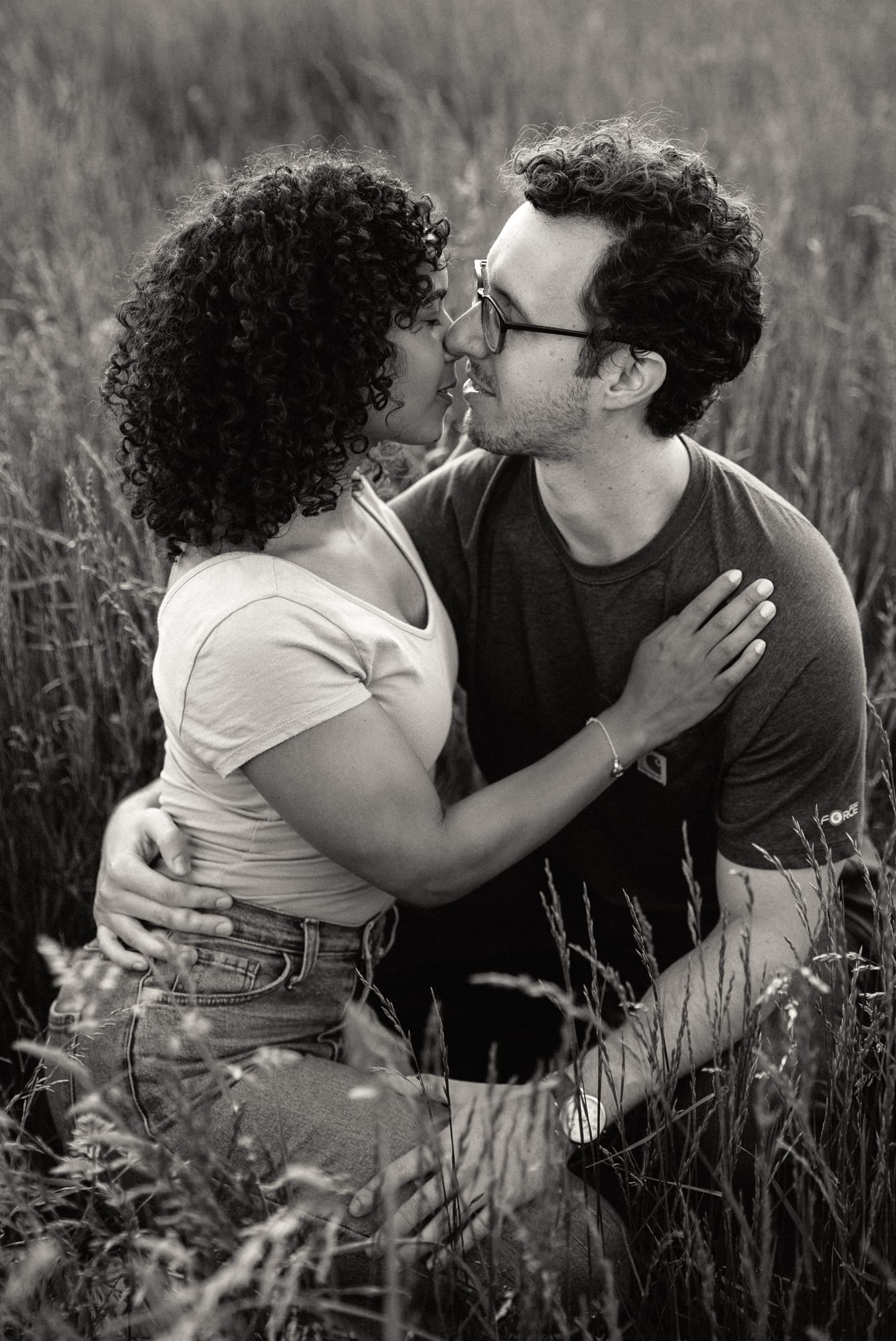 engagement photo of couple kissing in the grass