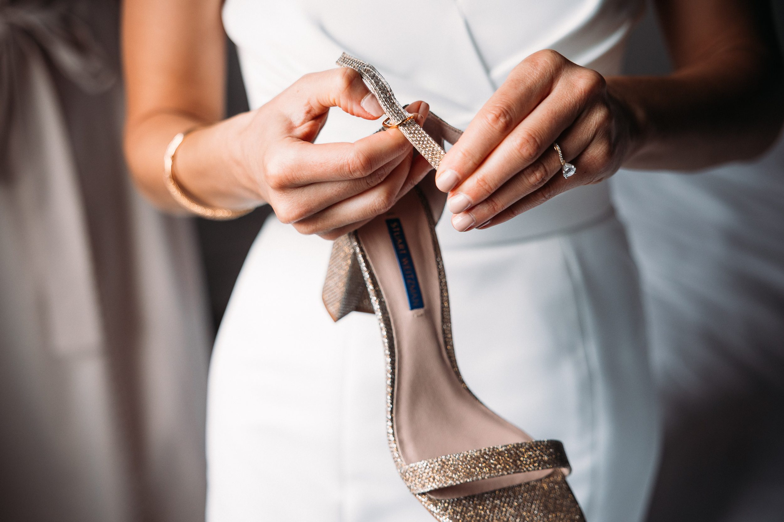 bride holding her shoes.