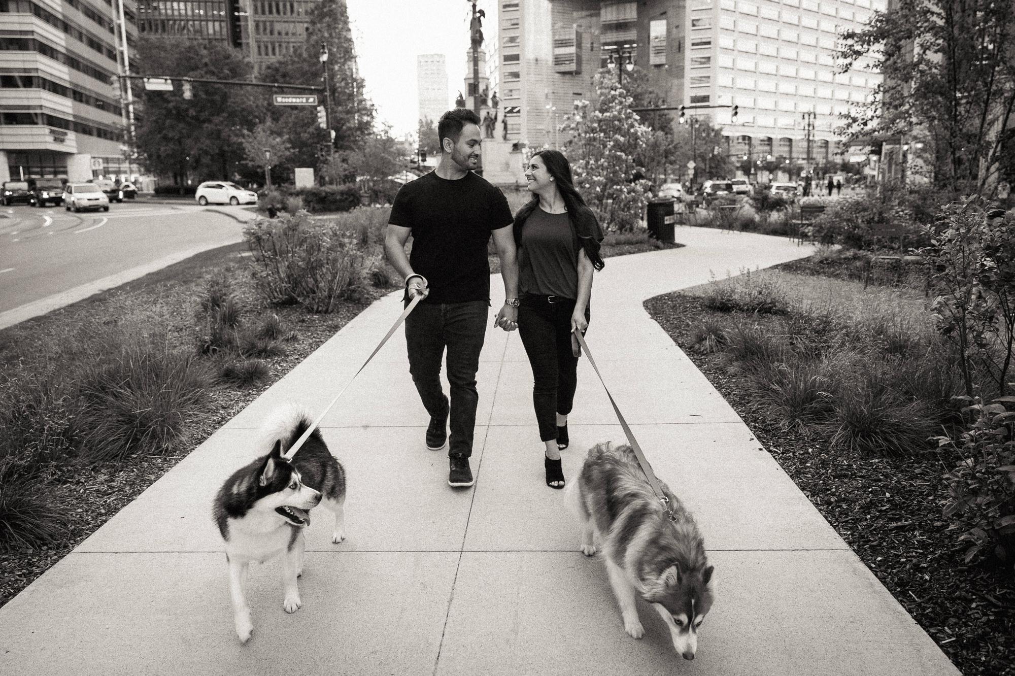 couple walking dogs in Downtown Detroit