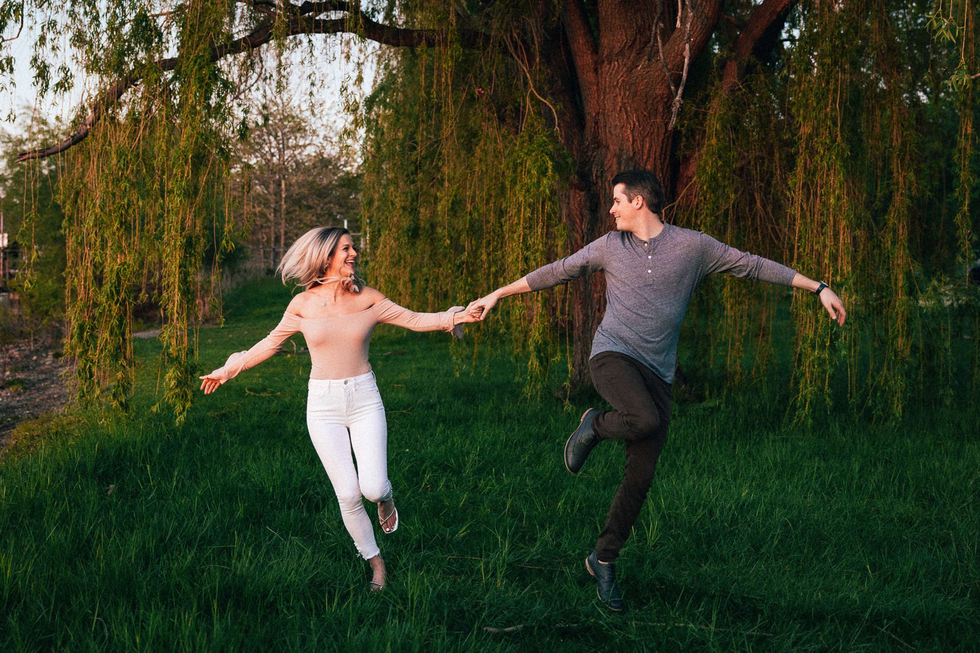 couple skipping in woods