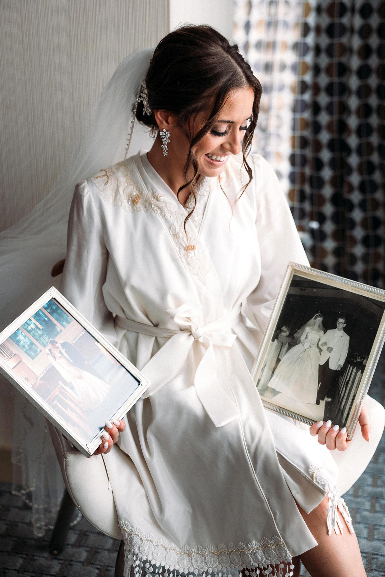 bride holding family wedding photos
