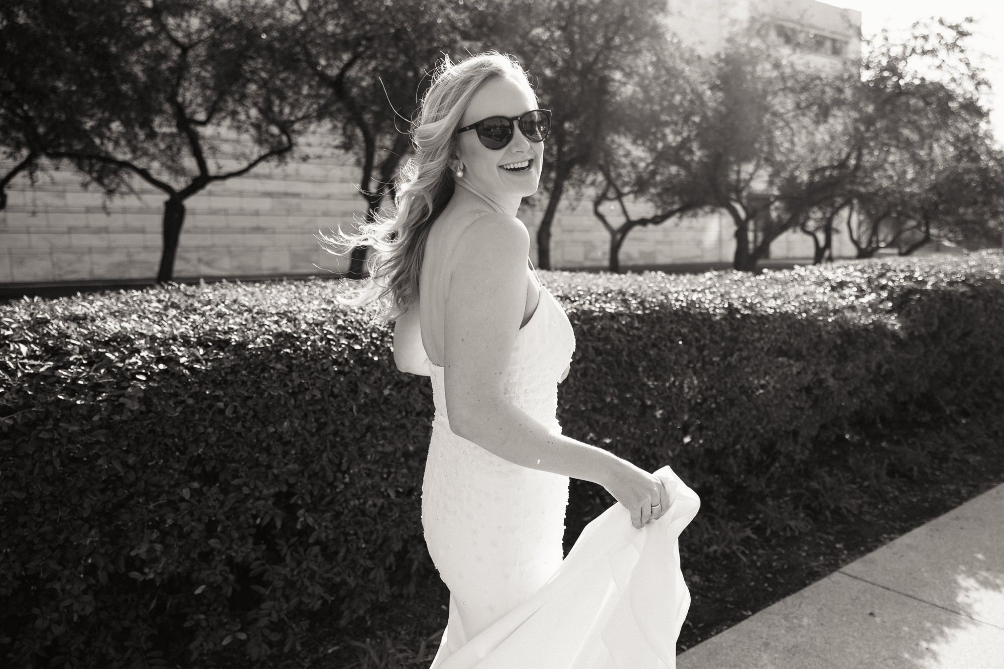 bride walking with sunglasses on
