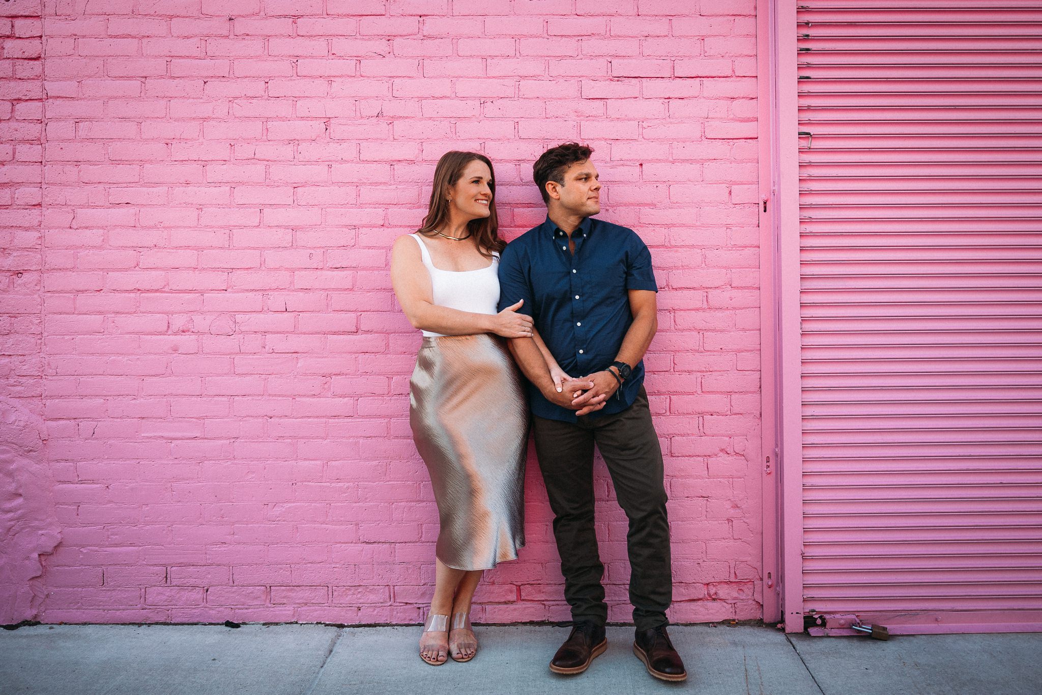 couple against pink wall