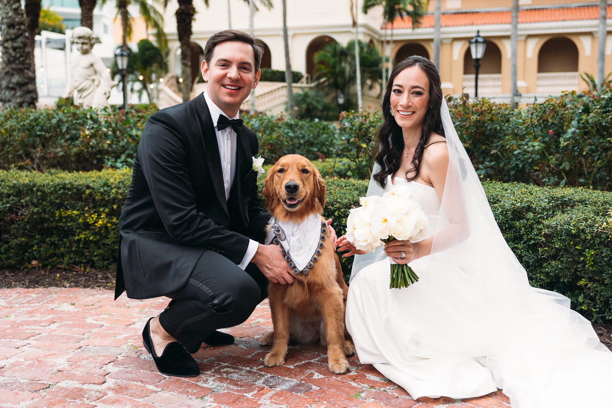 bride and groom with their puppy
