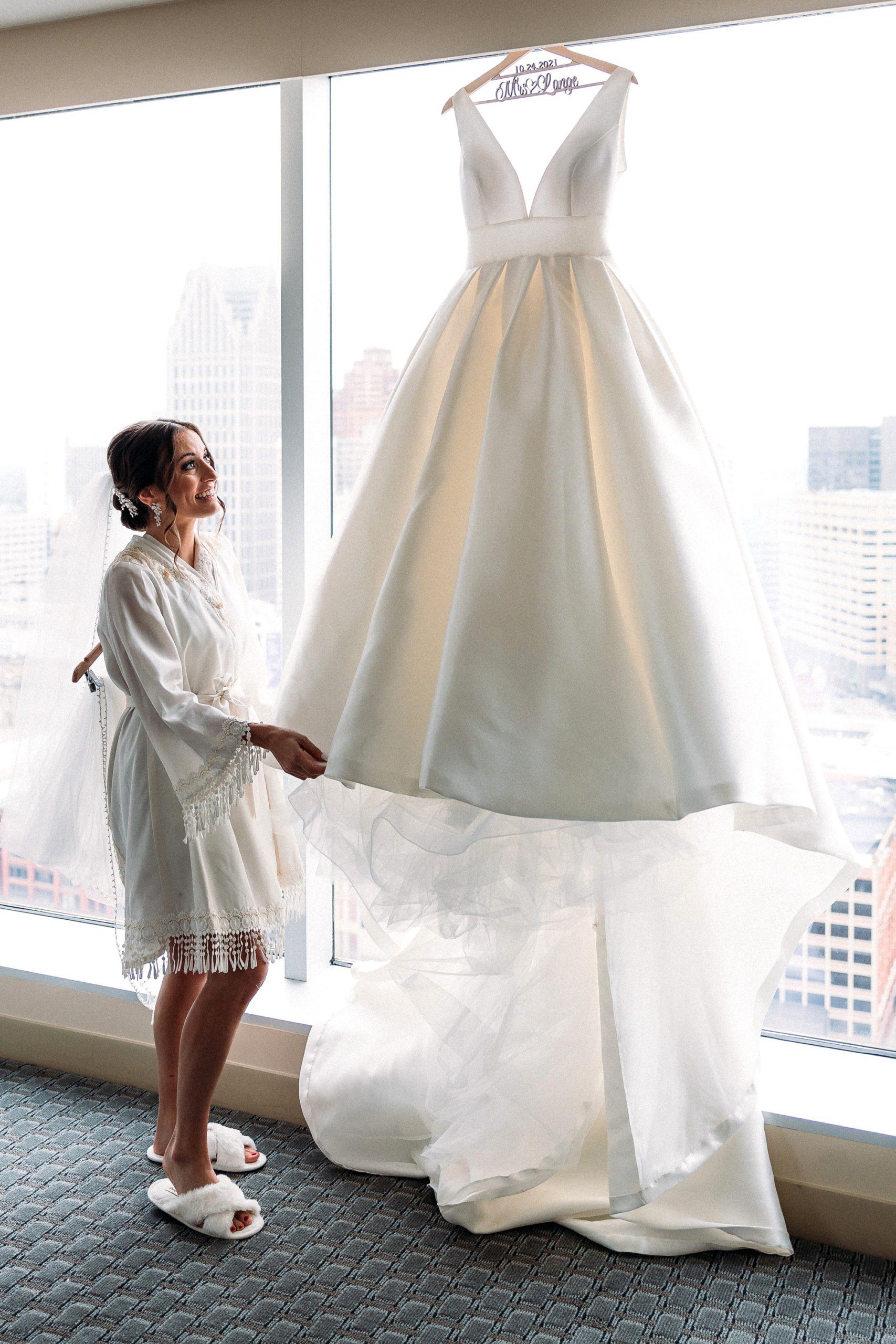 bride looking up at her wedding dress