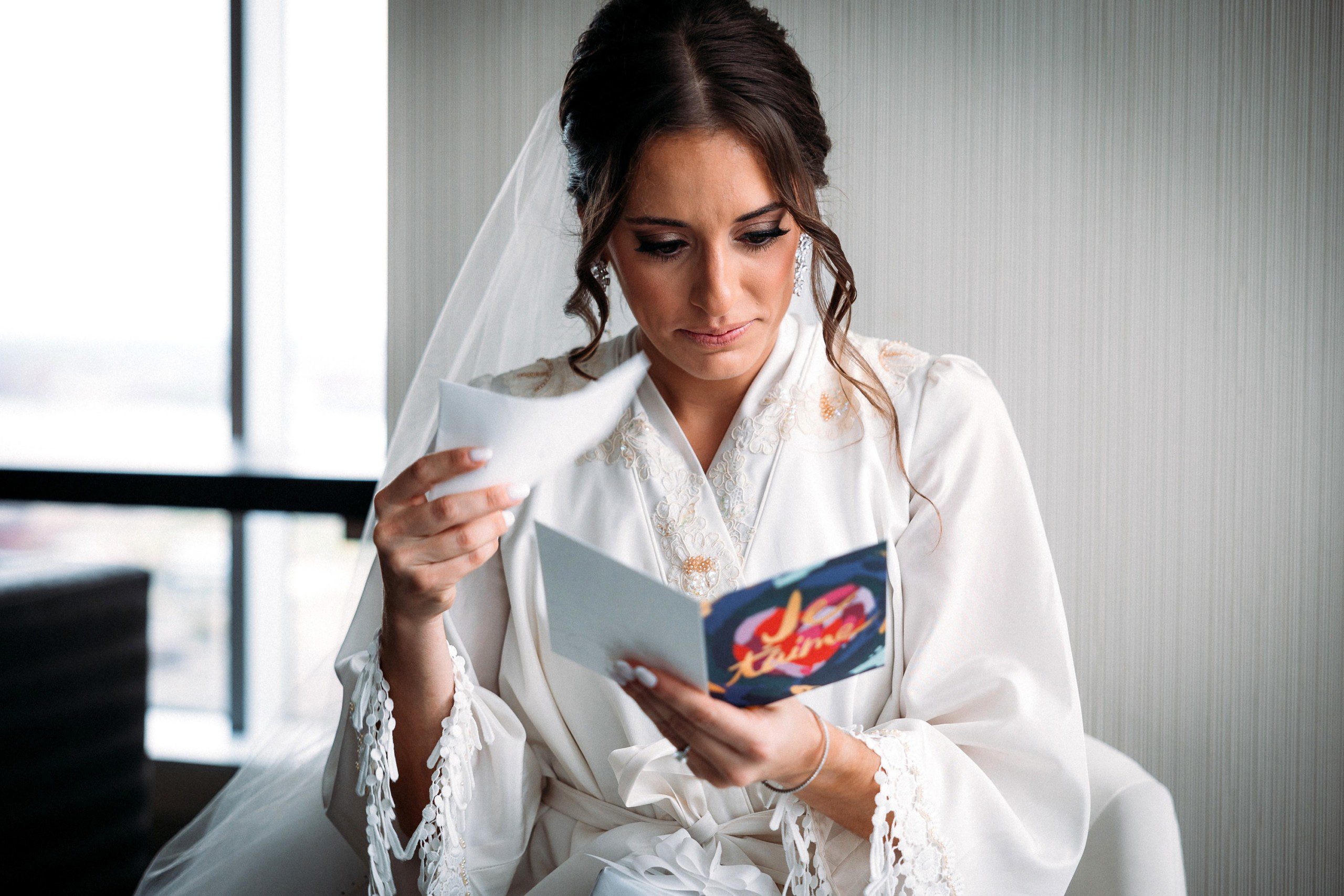 bride reading a wedding card