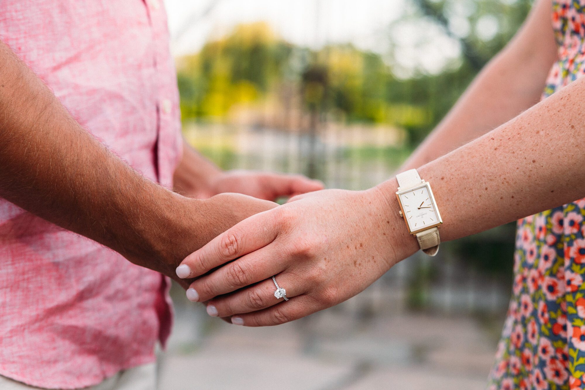 Couple Holding Hands Showing off Engagement Ring During Photoshoot