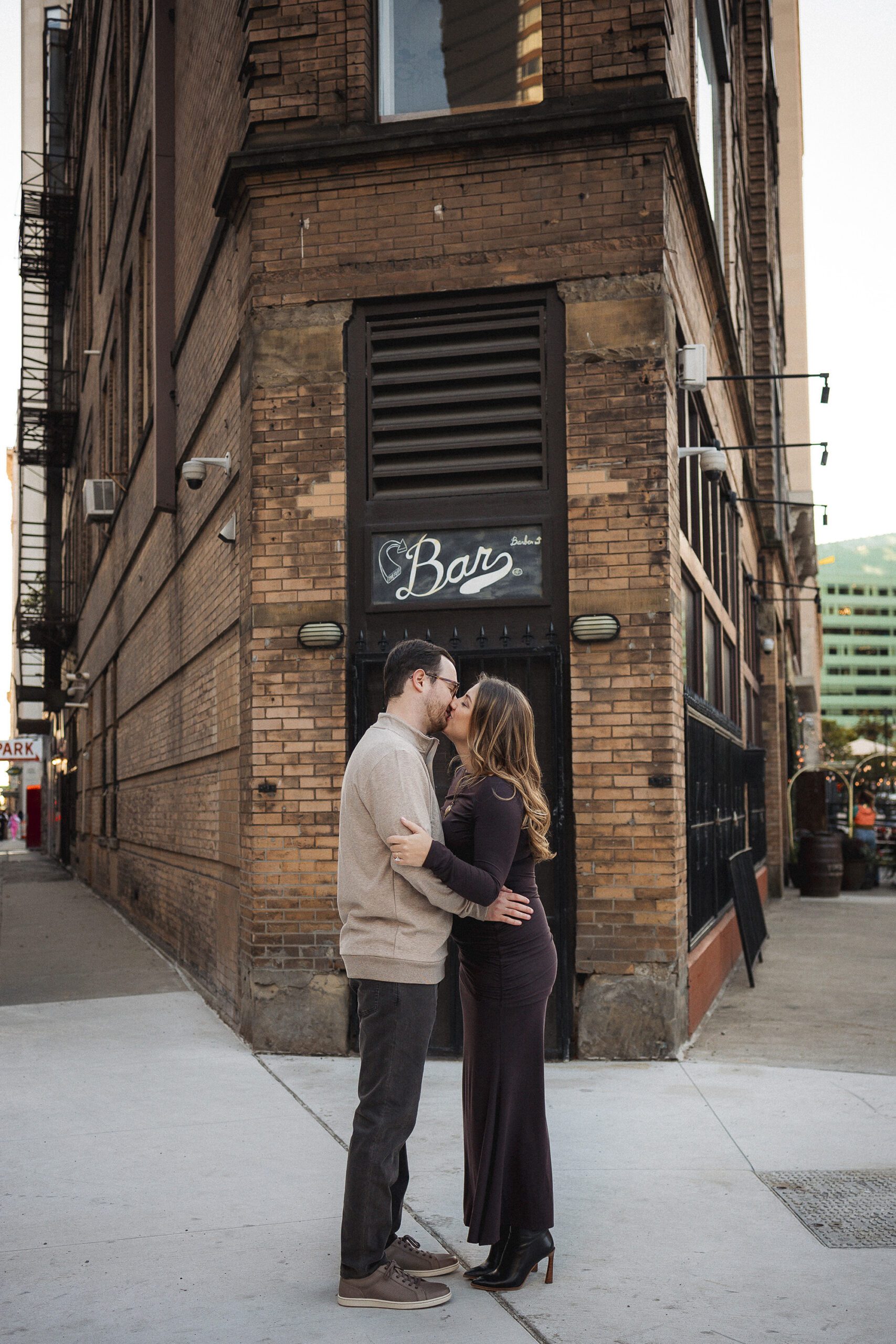 Couple embracing among downtown Detroit architecture