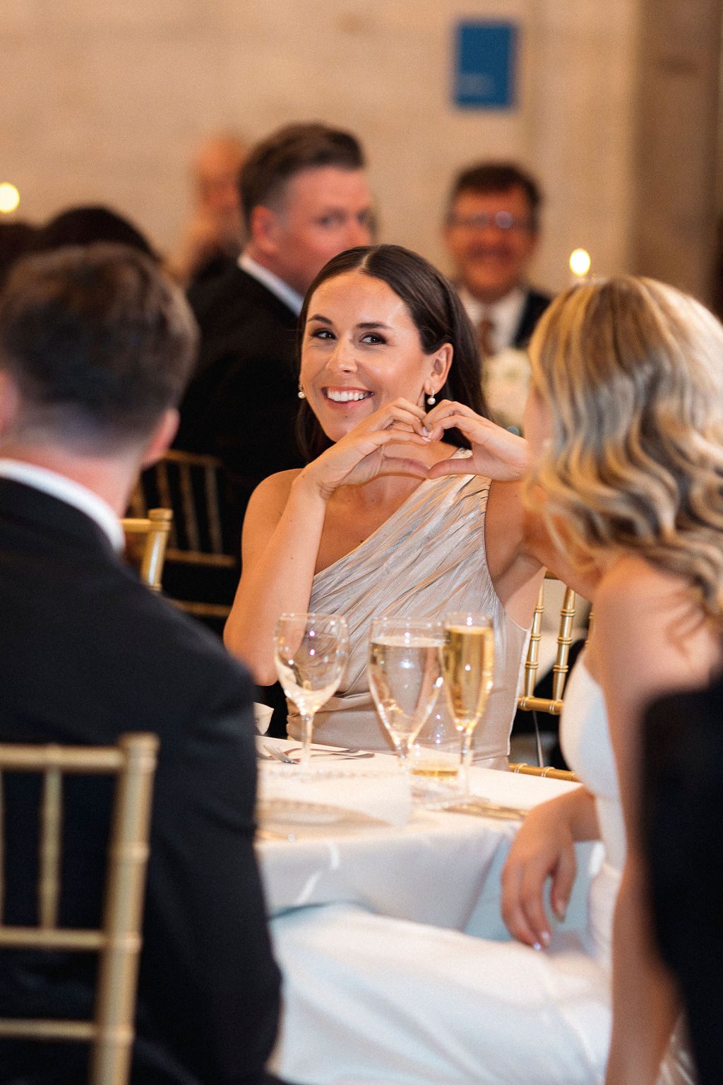 Bridesmaid Holding up Heart Hands at DIA Wedding Reception