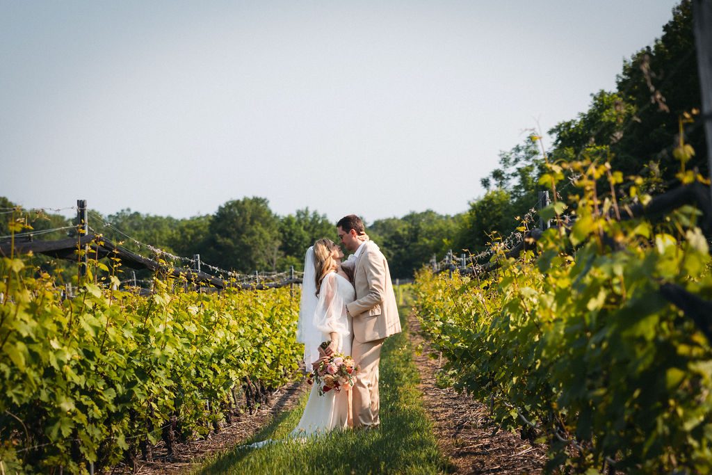 Bride and Groom Walk Through Vineyards at Brengman Family Wines Wedding