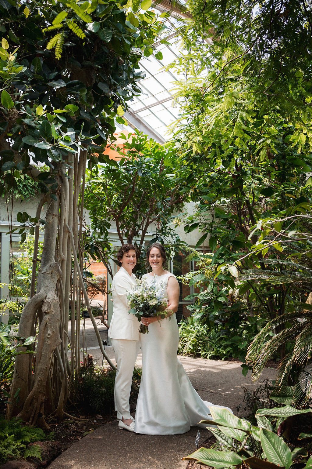 Brides Embrace in Greenhouse at Matthaei Botanical Gardens Wedding