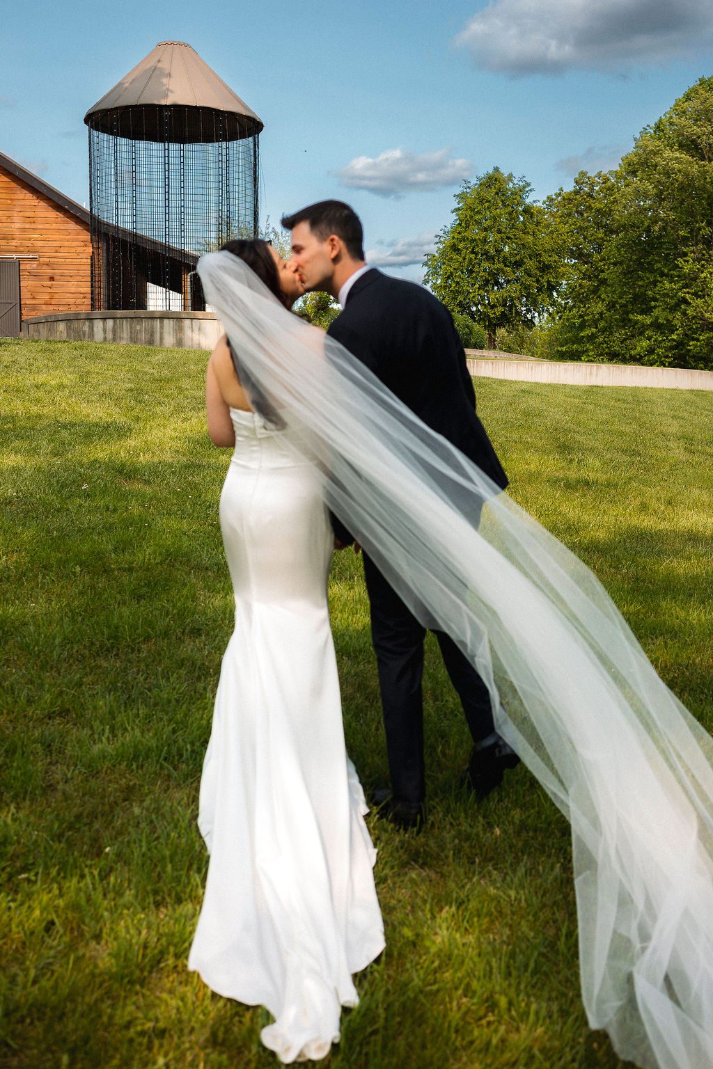 Bride and Groom Kiss During Outdoor Wedding MI