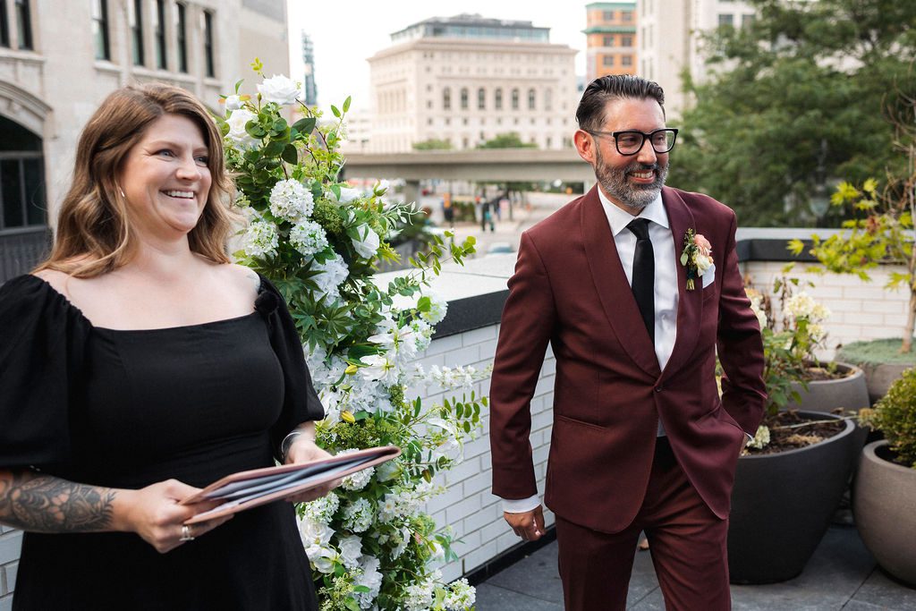 Groom Smiling as Bride Walks Down Aisle