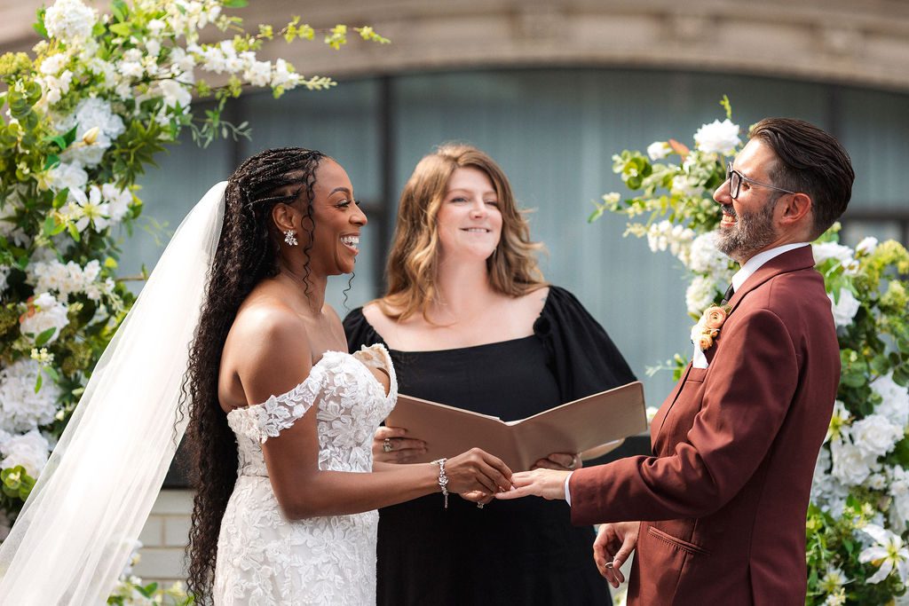 Bride and Groom Laugh During Rooftop Wedding Vows