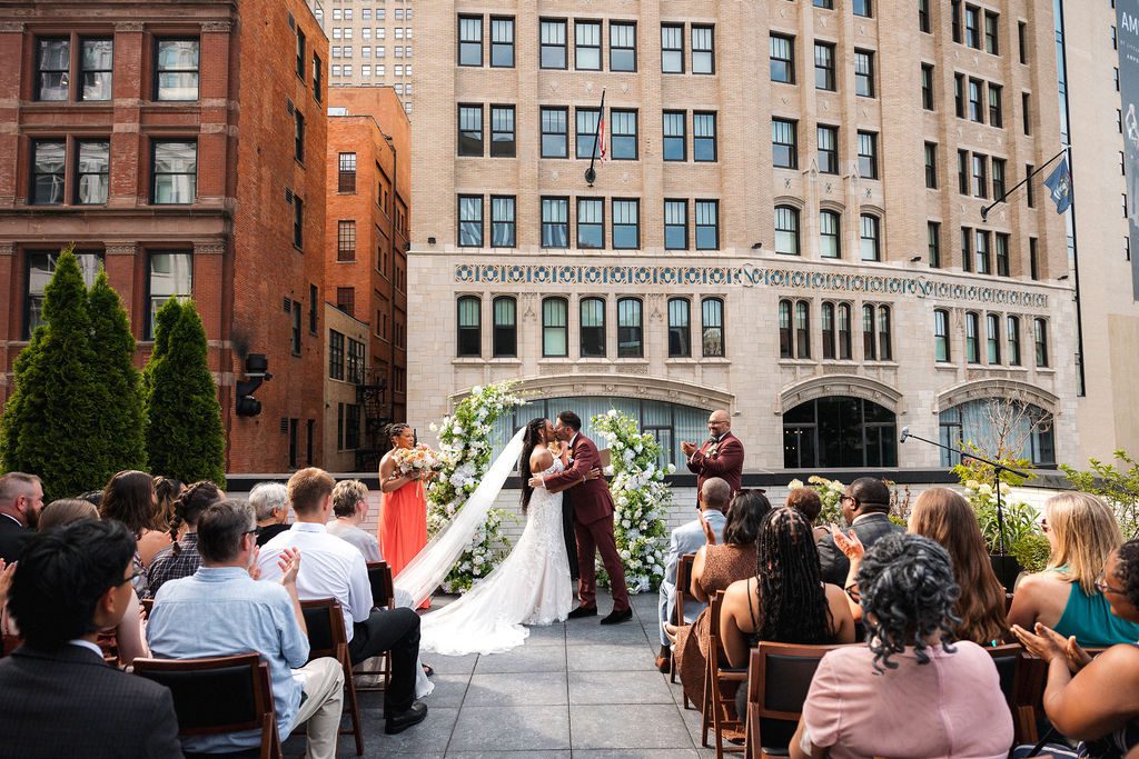 Bride and Groom Kiss on Rooftop Wedding Ceremony, Shinola Hotel
