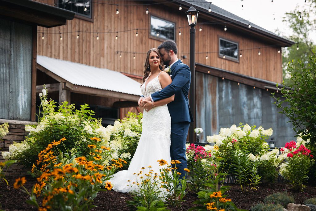 Bride and Groom Embrace During Tandale Nature Barn Wedding
