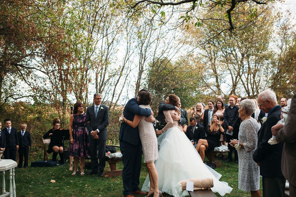 Bride and Groom Embrace Parents at The Valley at Frutig Farms Wedding