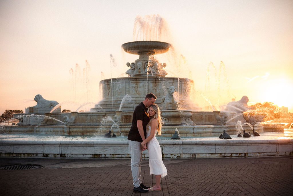 Couple Standing in Front of Fountain at Belle Isle Park for Engagement Session