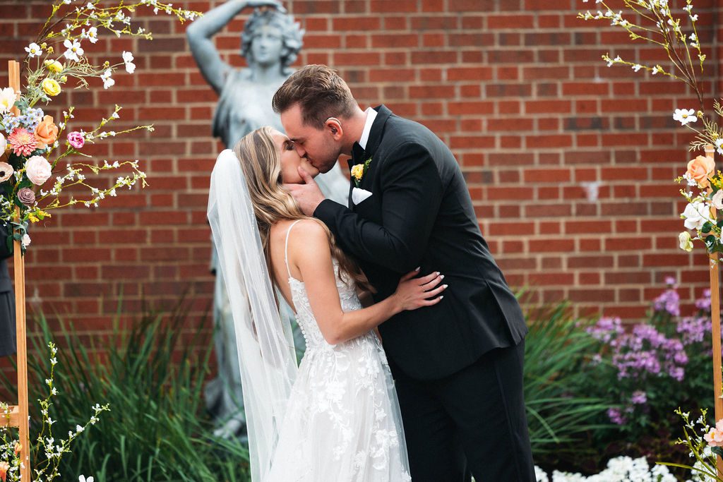 Bride and Groom Kiss During Wedding Ceremony, Lovett Hall